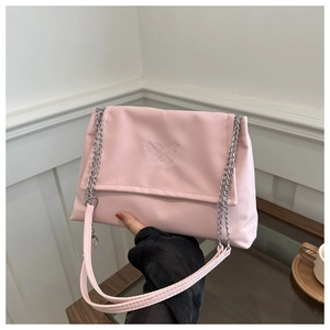 Detailed view of pink shoulder bag featuring butterfly embroidery and silver chain strap