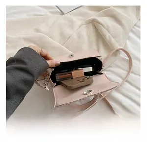 Pink patent leather mini bag interior showing capacity for phone and cosmetics