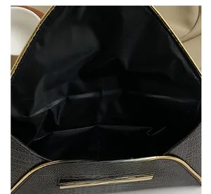 Detail showing crocodile texture and internal compartments of this brown evening bag