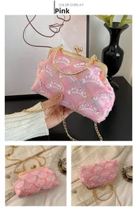 Detailed view of pink lace evening bag featuring wavy sequins and golden ring handle