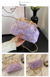 Detail of purple lace evening clutch bag with sequins embroidery and gold ring handle