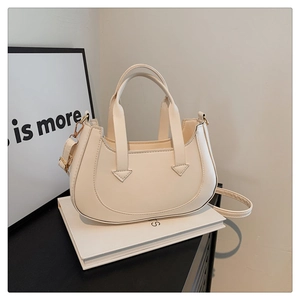 Detailed close-up showing the U-shaped opening and adjustable strap of the crescent bag