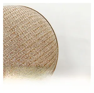 Macro shot of shimmering champagne gold sequined fabric and texture on the evening clutch bag