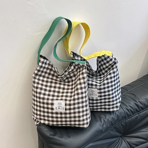 Détail du sac cabas en toile à carreaux avec sangle contrastée et étiquette EMIS