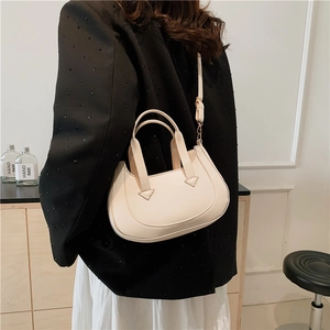 Minimalist beige crescent shoulder bag made of high quality smooth synthetic leather for women