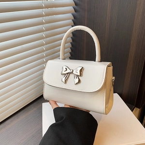 Fashionable cream white mini handbag with silver metallic bow and top handle