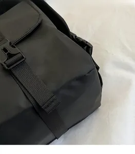 Close-up of waterproof nylon material and durable plastic buckle on a black crossbody bag