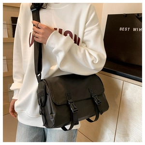 Detail of waterproof nylon messenger bag with buckle closure and wide strap