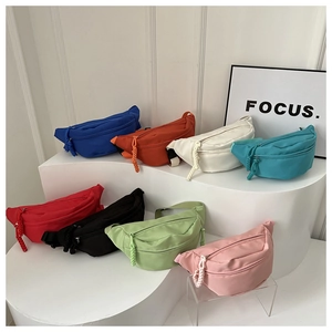 Detailed macro view showing eight vibrant colors of minimalist canvas belt bags on display