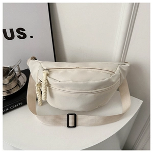 Detail of off-white canvas belt bag with woven zipper pull and adjustable strap