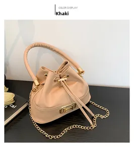 Top view of khaki drawstring bucket bag with gold metal buckle and chain strap detail