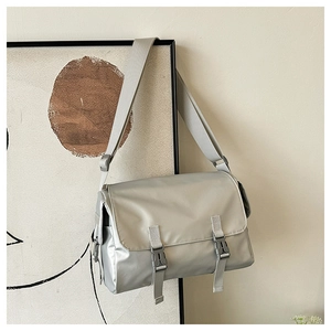 Silver-grey waterproof nylon messenger bag with buckle closure and wide shoulder strap