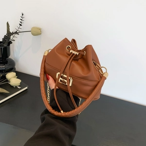 Elegant brown leather bucket bag with gold hardware and chain strap for summer 2024 fashion