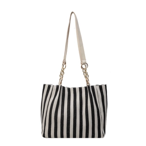 Minimalist black and white vertical striped canvas tote bag with gold chain strap detail