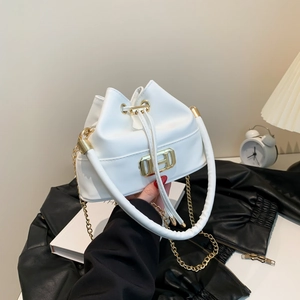 White minimalist bucket bag with gold H-lock, thick top handle, and chain strap for women
