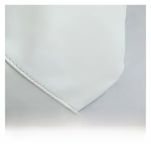 Detailed macro view of white synthetic leather texture and neat stitching on a tote bag