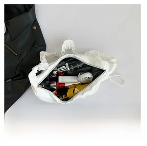 Top-down view of spacious white pleated tote bag showing large capacity for essentials