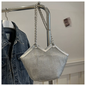 Gros plan sur le tissu en strass argentés et la bandoulière en chaîne métallique du sac cabas