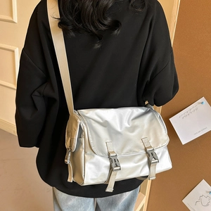 Silver large crossbody messenger bag with metallic finish and adjustable strap