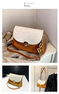 Detail of orange suede bag with white croc-embossed leather flap and gold chain