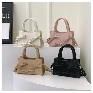 Multi-color view of four stylish handbags with decorative bows and metal zipper closure