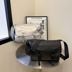 Large solid color messenger bag in black and silver with double buckles for women