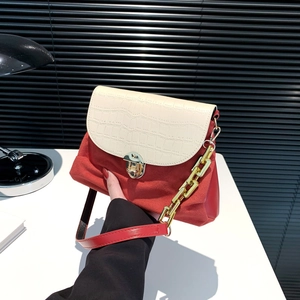 Fashionable red and cream patchwork crossbody bag with gold lock and chain strap