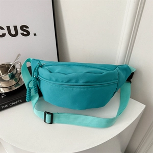 Waterproof nylon crossbody chest bag in bright teal with adjustable woven strap for women