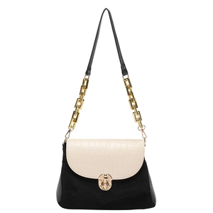 Black and cream crossbody bag with faux crocodile texture and gold chain strap