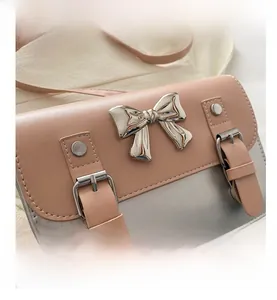 Close-up of the stylish pink and grey contrast PU leather shoulder bag with a silver bow