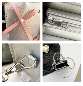 Détails du sac argenté métallisé avec nœud en cuir rose, perle et fermeture éclair