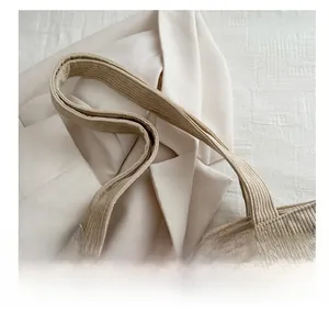 Close-up of wide corduroy strap and striped texture on the khaki canvas tote bag