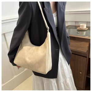 Detailed view of beige faux leather tote bag with natural wrinkled texture and shoulder strap