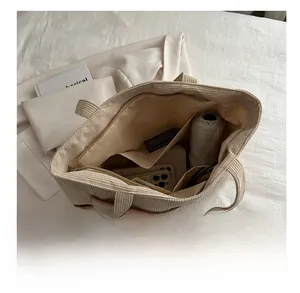 Interior view of large capacity corduroy tote bag showing daily essentials organization