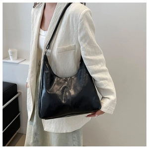 Detail of minimalist black oil wax leather tote bag with elegant vertical stitching details