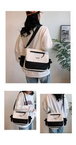 Detail of black and white canvas messenger bag with adjustable strap and fashion label