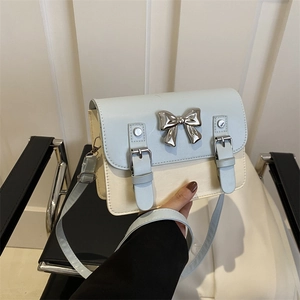Fashionable blue and cream small square bag with silver bow accent and adjustable strap