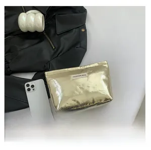 Chic gold metallic makeup bag with FASHION BAG label and zipper closure for women