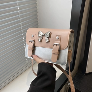 Fashionable contrast color shoulder bag with metallic bow and silver mirror finish