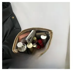 Top-down macro view showing large internal capacity of the gold metallic makeup bag