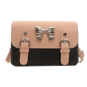 Fashionable contrast color satchel bag with silver bow accent and crossbody strap