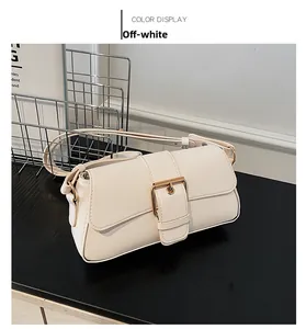Detailed close-up of a cream-white leather flap bag featuring a stylish gold buckle accent