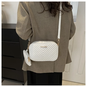 Detailed back view of a white quilted crossbody bag with a detachable round coin purse set