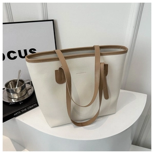 Close-up of cream tote bag with brown straps and FASHION & BAG text on display stand