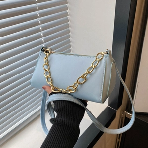 Chic light blue faux leather baguette bag with chunky gold chain for casual commute