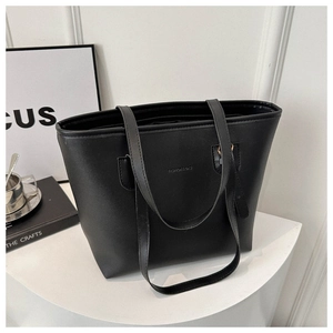 Close-up of black textured leather tote bag with Fashion & Bag embossed logo detailing