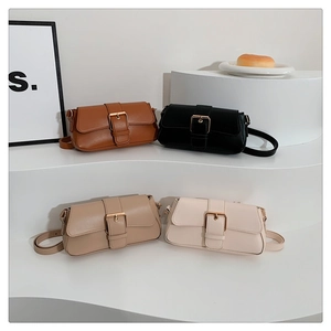 Detail of four Korean minimalist shoulder bags in brown, black, grey and white with gold buckles