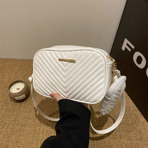 Elegant white quilted crossbody bag with golden hardware and matching small coin purse