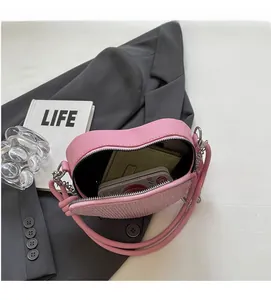 Detail shot of the spacious interior of this pink heart-shaped sequin crossbody bag