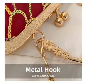 Macro shot of gold floral hardware hook and clasp on red sequin evening clutch